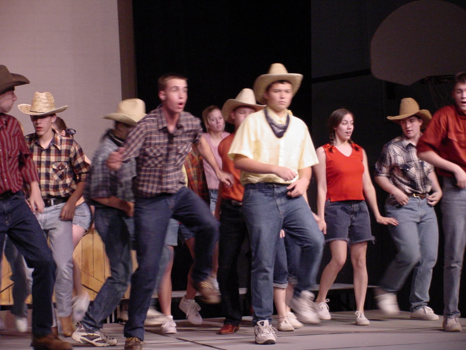 Cast in western costumes on stage