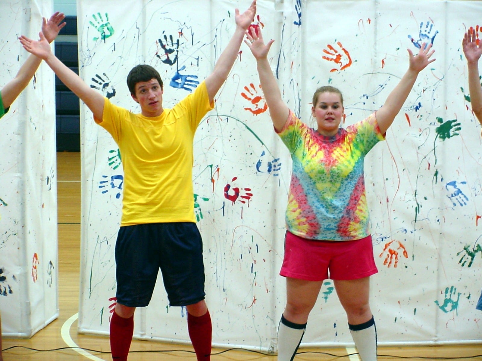 Two performers on the gym stage