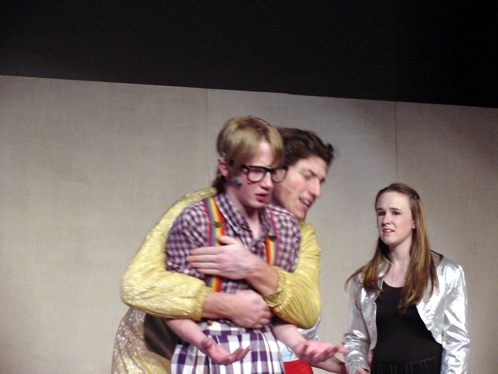 Three students in a comic stage moment