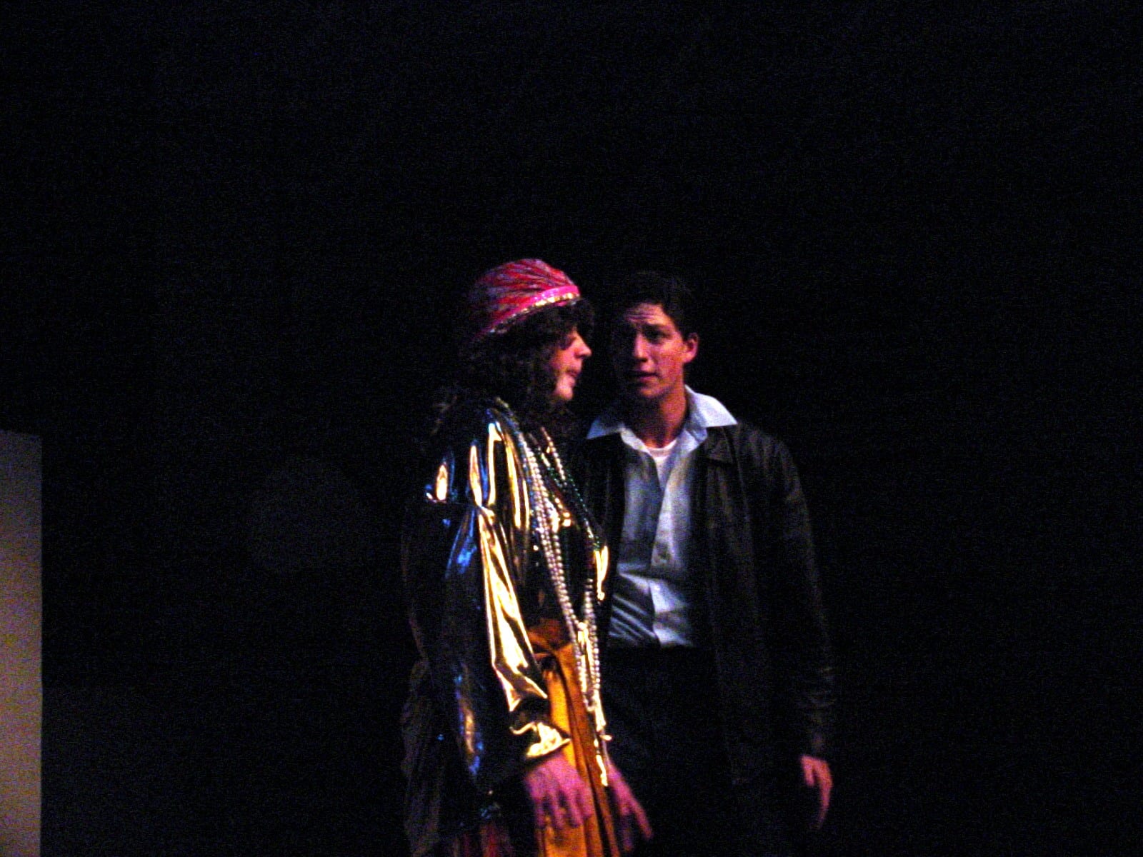 Two performers in costume on stage