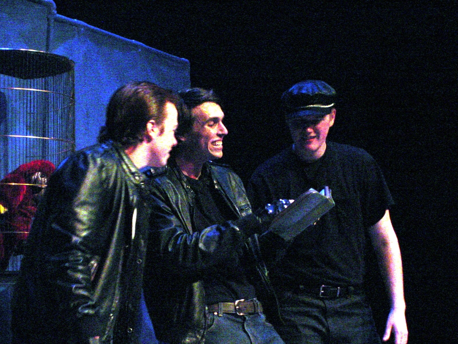 Three cast members in leather jackets