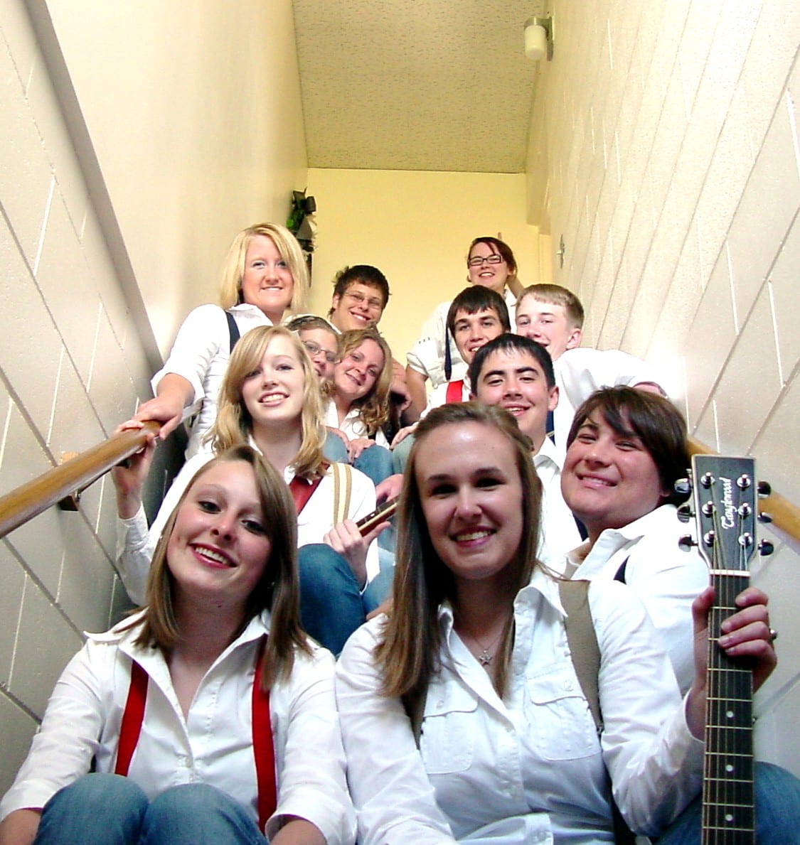 Cast gathered on a stairway