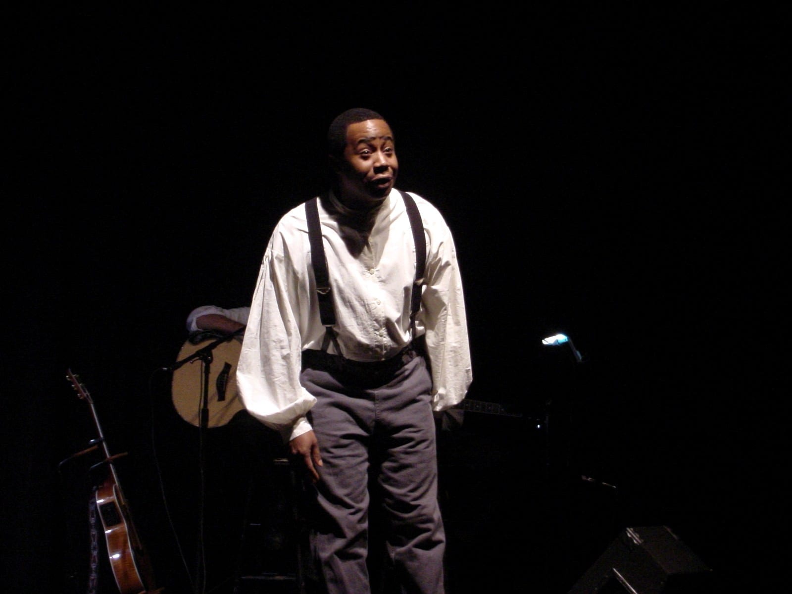 Performer with guitar on stage