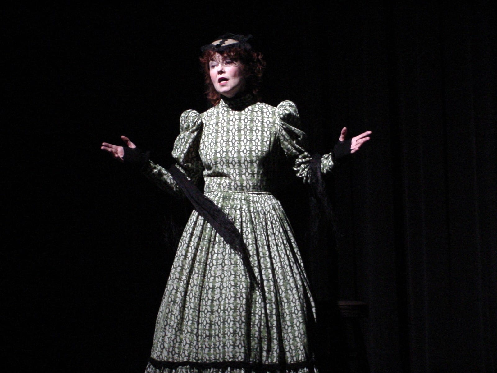 Performer mid-monologue on stage
