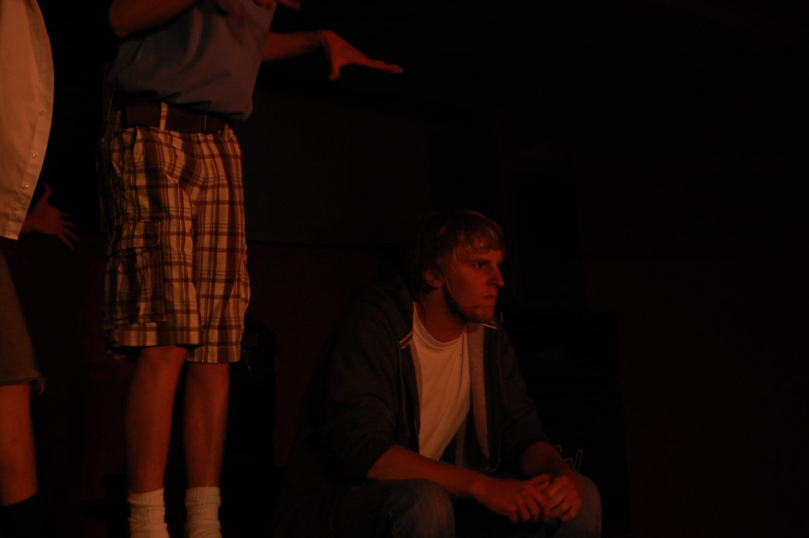 Performer in red stage lighting