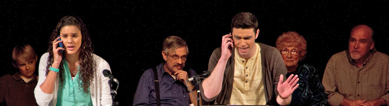Cast on stage with phones