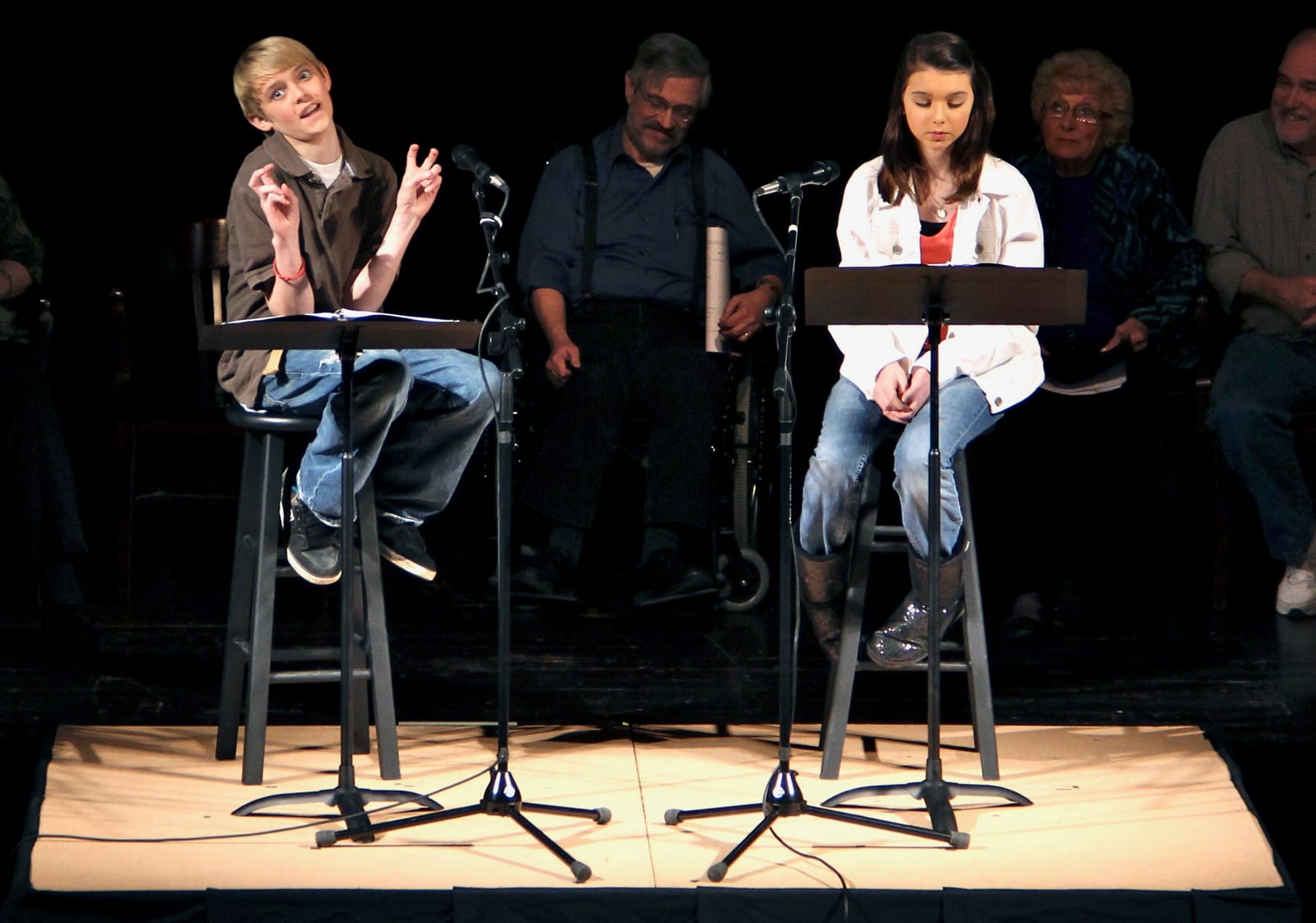 Two young performers on stools