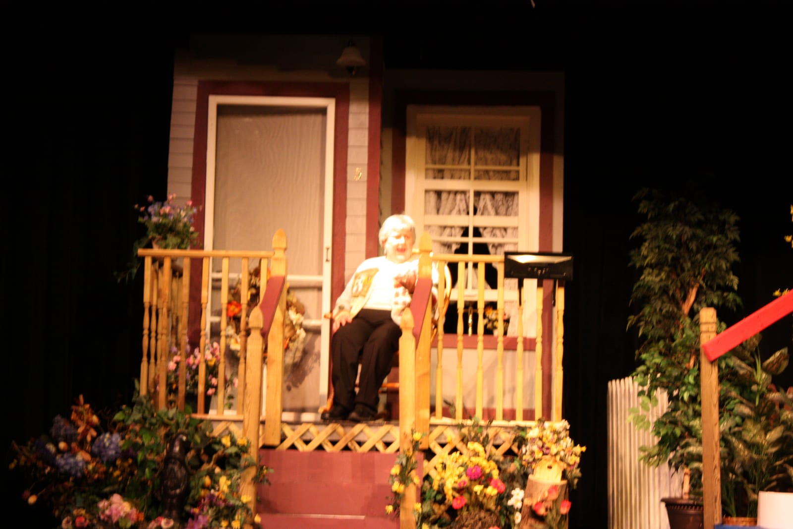 A character on the porch amid the flowers and railings