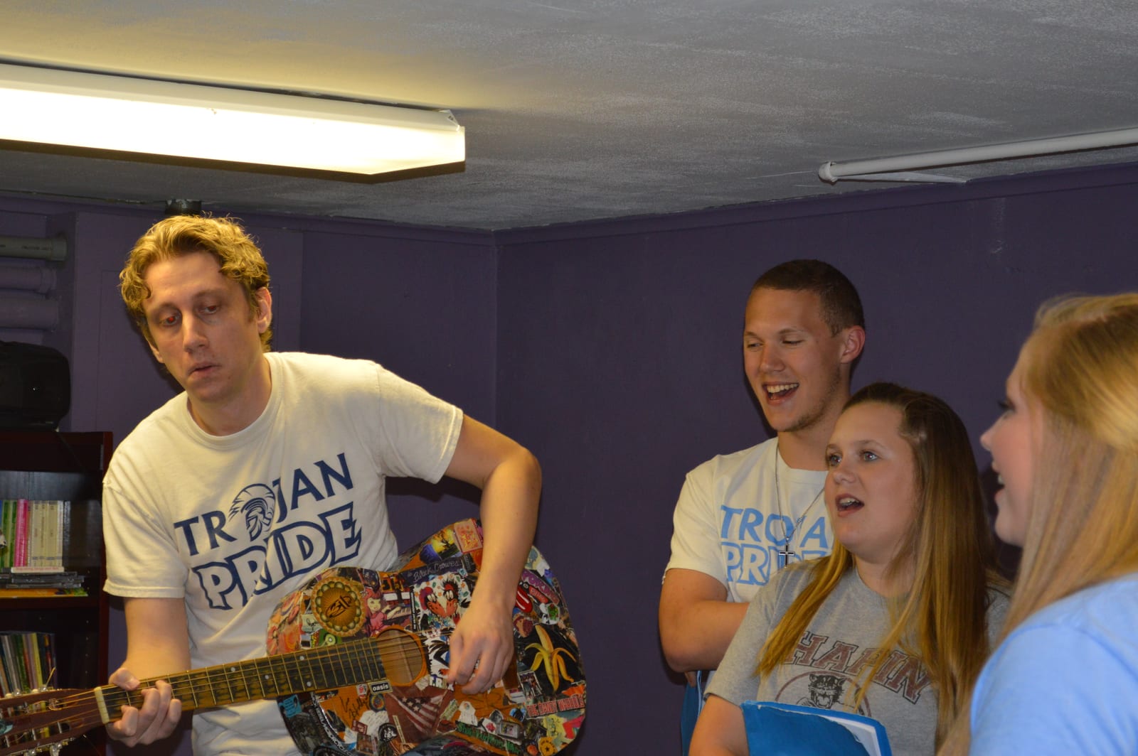 The show's musician accompanying the cast on guitar