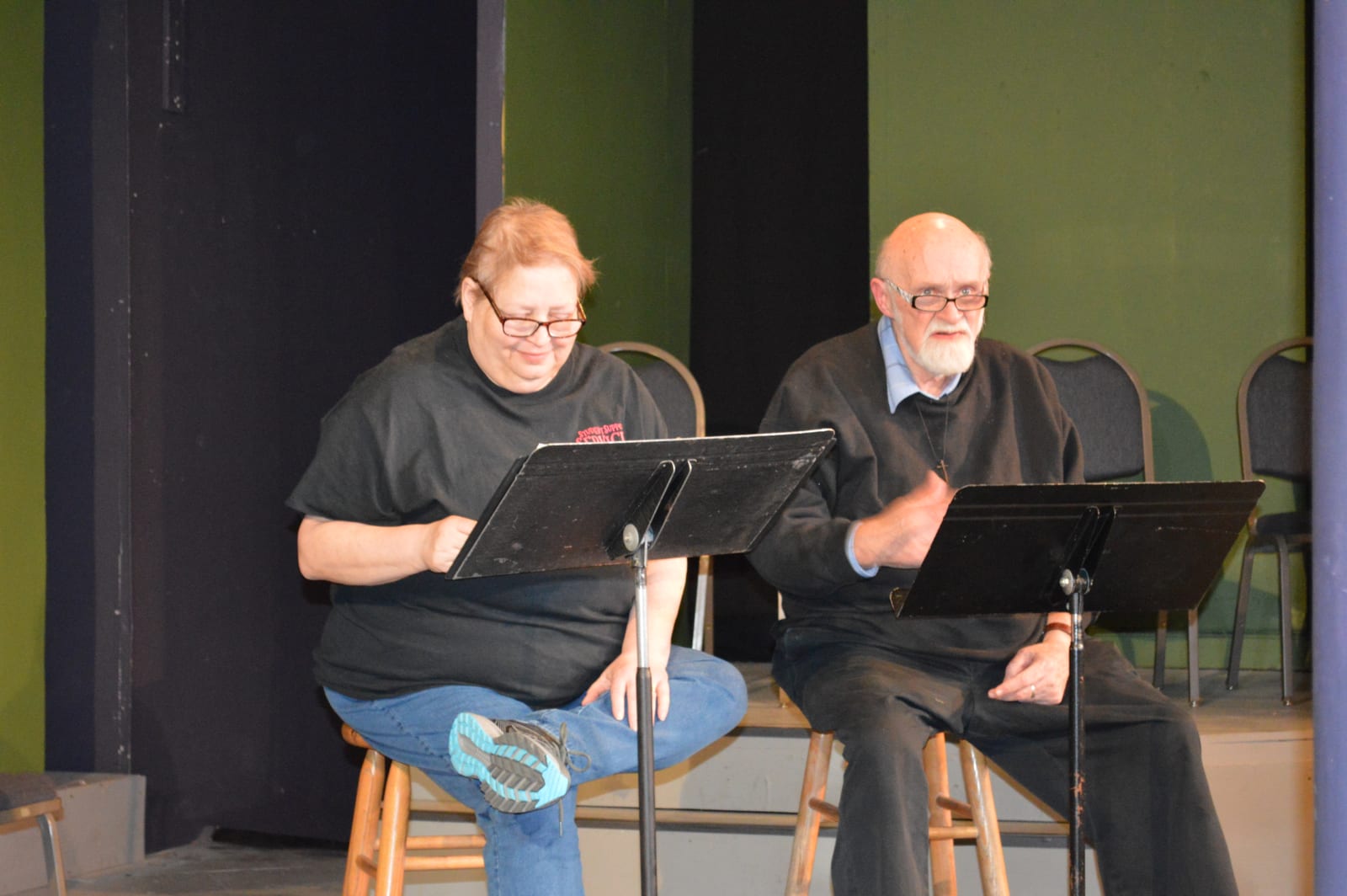 Readers reading from their scripts