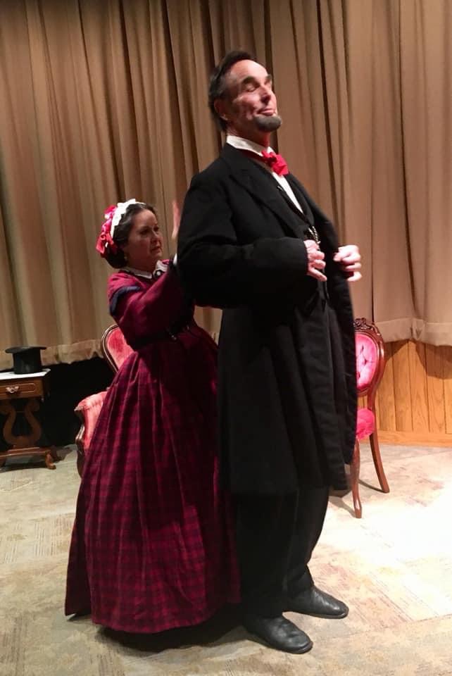 Mary Todd Lincoln adjusting Lincoln's coat as he stands