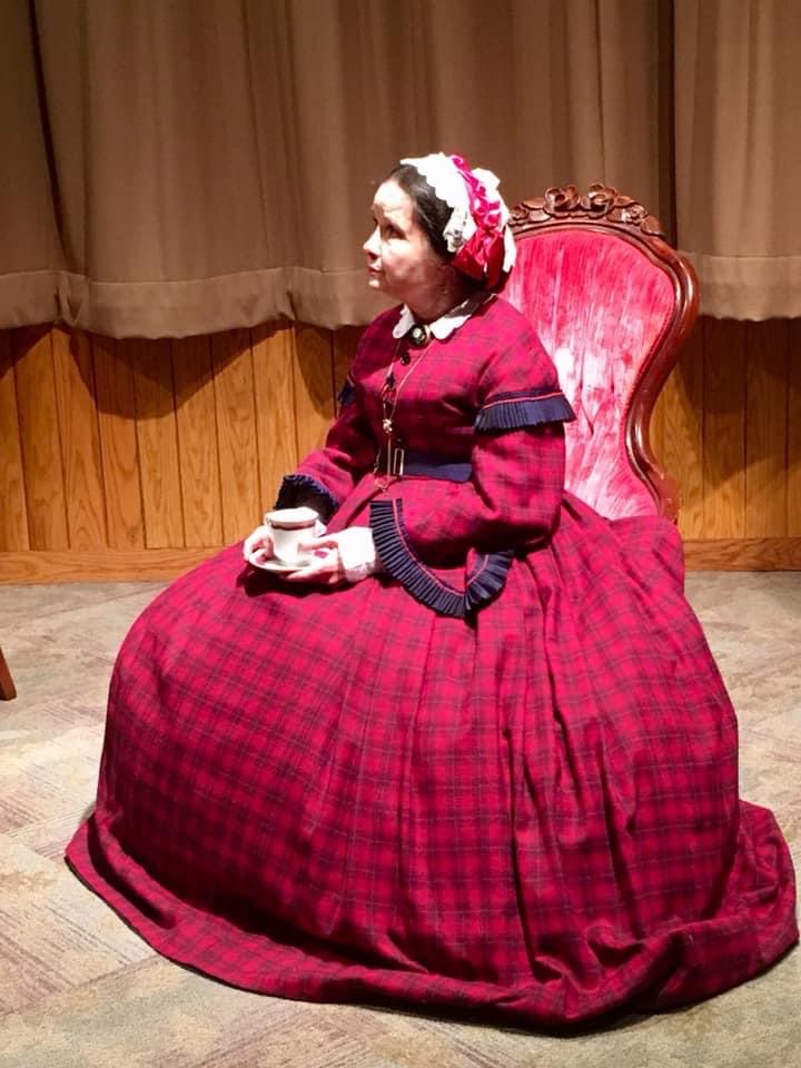 Mary Todd Lincoln seated with a teacup and saucer, in profile