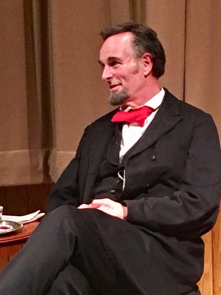 Lincoln in conversation, seated